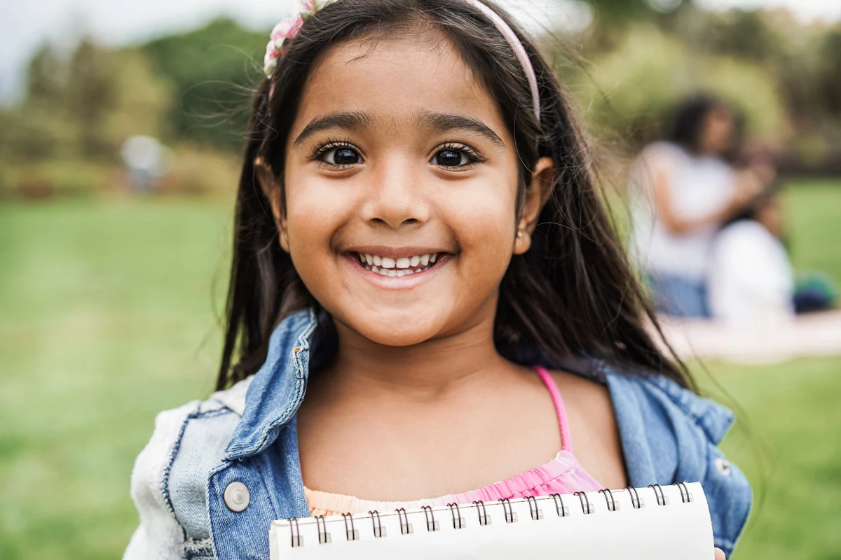A smiling child at a park